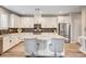 Modern kitchen boasts stainless appliances, granite countertops, island with seating, and ample cabinet space at 3002 Coveri Ct, Las Vegas, NV 89141