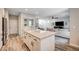 Open kitchen concept flowing into the living room, featuring granite island and modern appliances at 3002 Coveri Ct, Las Vegas, NV 89141