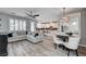 Open-concept living room with wood floors, a gray sofa, and seamless transition to a modern kitchen at 3002 Coveri Ct, Las Vegas, NV 89141