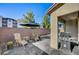 Private outdoor living space with wood furniture, barbecue, and privacy wall at 3002 Coveri Ct, Las Vegas, NV 89141