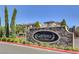 Stone sign welcomes you to Cortona at Southern Highlands, surrounded by lush landscaping at 3002 Coveri Ct, Las Vegas, NV 89141
