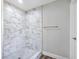 Close up of a tiled shower with marble walls and mosaic tile floor at 3016 Mount Charleston Dr, Pahrump, NV 89048