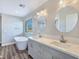 Stylish bathroom with double sinks, marble countertops, modern fixtures, a soaking tub, and a large window at 3016 Mount Charleston Dr, Pahrump, NV 89048