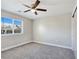 Well-lit bedroom featuring plush carpet, a ceiling fan, a window with blinds, and a sliding door closet at 3016 Mount Charleston Dr, Pahrump, NV 89048