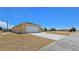 Side view of home exterior showcasing well maintained yard and driveway at 3016 Mount Charleston Dr, Pahrump, NV 89048