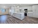 Bright, open-concept kitchen with an island, white cabinets, and stainless steel appliances at 3016 Mount Charleston Dr, Pahrump, NV 89048