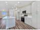 Modern kitchen with white cabinetry, stainless steel appliances, and a large kitchen island at 3016 Mount Charleston Dr, Pahrump, NV 89048