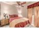 Comfortable bedroom featuring a ceiling fan, side table, and warm lighting at 312 Purple Passion Ave, North Las Vegas, NV 89032
