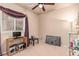 Neutral bedroom with a ceiling fan and window at 312 Purple Passion Ave, North Las Vegas, NV 89032