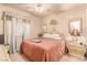 Comfortable bedroom with ceiling fan, window, and a classic bed frame plus matching side table at 312 Purple Passion Ave, North Las Vegas, NV 89032