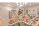 Well-appointed dining room featuring a glass table, chandelier lighting, and elegant decor at 312 Purple Passion Ave, North Las Vegas, NV 89032