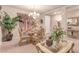 Formal dining area with a glass table, decorated with flowers and plants, and elegant furnishings at 312 Purple Passion Ave, North Las Vegas, NV 89032