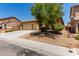 Inviting single-Gathering home with desert landscaping, a long driveway, and a two-car garage at 312 Purple Passion Ave, North Las Vegas, NV 89032