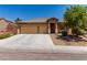 Attractive home with a well-maintained lawn, a spacious driveway, and a convenient two-car garage at 312 Purple Passion Ave, North Las Vegas, NV 89032