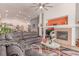 Inviting living space with a sectional sofa, fireplace, and an open floor plan to the kitchen at 312 Purple Passion Ave, North Las Vegas, NV 89032