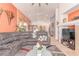 Bright, open living area with a modern sectional, neutral tones, and easy access to the kitchen at 312 Purple Passion Ave, North Las Vegas, NV 89032