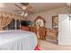 Comfortable main bedroom features a four-poster bed, wooden furniture, and neutral color palette at 312 Purple Passion Ave, North Las Vegas, NV 89032