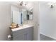 Modern bathroom with gray vanity, large mirror, and contemporary fixtures at 3151 Soaring Gulls Dr # 1021, Las Vegas, NV 89128