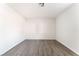 Clean, minimalist bedroom featuring grey wood flooring and neutral-toned paint throughout at 3151 Soaring Gulls Dr # 1021, Las Vegas, NV 89128