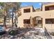Condo exterior featuring stairs to the second floor and desert landscaping with a sidewalk leading to the building at 3151 Soaring Gulls Dr # 1021, Las Vegas, NV 89128