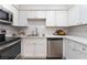 Modern kitchen featuring stainless steel appliances, white cabinets, and a view of the dining area at 3151 Soaring Gulls Dr # 1021, Las Vegas, NV 89128
