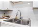 Close-up of a stainless steel kitchen sink with modern faucet and white backsplash at 3151 Soaring Gulls Dr # 1021, Las Vegas, NV 89128