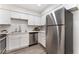 Updated kitchen with white cabinets, stainless steel appliances, and modern countertops at 3151 Soaring Gulls Dr # 1021, Las Vegas, NV 89128