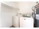 Bright laundry area with a white Maytag washer and dryer, and a gray Rheem water heater at 3151 Soaring Gulls Dr # 1021, Las Vegas, NV 89128