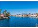 Picturesque waterfront view with beautiful homes, boats, and palm trees along the tranquil water at 3151 Soaring Gulls Dr # 1021, Las Vegas, NV 89128