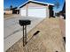 Suburban home with a two-car garage, low-maintenance desert landscaping, and a sunny, open driveway at 3318 Covey Ln, Las Vegas, NV 89115