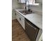 This kitchen features white cabinets, stainless steel appliances, and wood floors at 3318 Covey Ln, Las Vegas, NV 89115