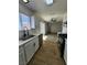 This kitchen features white cabinets, stainless steel appliances, granite countertops, and wood floors at 3318 Covey Ln, Las Vegas, NV 89115