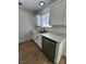 This kitchen features white cabinets, stainless steel appliances, wood floors, and granite countertops at 3318 Covey Ln, Las Vegas, NV 89115
