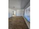 Bright living room features wood-look floors and a large window that lets in an abundance of natural light at 3318 Covey Ln, Las Vegas, NV 89115