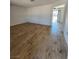 Open floor plan displaying wood-look floors and white walls, creating a bright and spacious feel at 3318 Covey Ln, Las Vegas, NV 89115