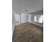 Open living area showcasing wood-look flooring, white walls, and natural light through the window at 3318 Covey Ln, Las Vegas, NV 89115