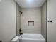 Bathroom showcasing a modern bathtub with tiled wall and matte black fixtures at 3327 Erva St # 222, Las Vegas, NV 89117