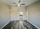 Neutral bedroom with fan, modern floors and doorway to the updated bathroom at 3327 Erva St # 222, Las Vegas, NV 89117