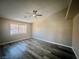 Spacious bedroom with ceiling fan, large window, and modern flooring at 3327 Erva St # 222, Las Vegas, NV 89117