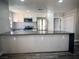 Bright kitchen featuring white cabinets, stainless steel appliances, and a breakfast bar at 3327 Erva St # 222, Las Vegas, NV 89117