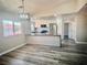 Bright kitchen featuring stainless steel appliances, bar seating, and wood-look flooring at 3327 Erva St # 222, Las Vegas, NV 89117