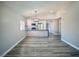 Open-concept living area with wood floors and a view of the modern kitchen at 3327 Erva St # 222, Las Vegas, NV 89117