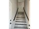 Updated staircase with modern railings and wood-look steps leading upwards at 3327 Erva St # 222, Las Vegas, NV 89117