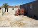 Backyard featuring a small wooden deck, detached building, and block wall fencing at 3439 Cox St, North Las Vegas, NV 89032