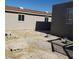 View of the backyard showcasing a detached building with skylights and partially constructed walls at 3439 Cox St, North Las Vegas, NV 89032