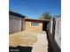 Backyard with a small, plywood shed, block wall, and wire fencing at 3439 Cox St, North Las Vegas, NV 89032