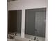 Bathroom featuring dual sinks and mirrors with a white countertop at 3439 Cox St, North Las Vegas, NV 89032