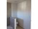 Neutral colored bathroom featuring a toilet and the corner of a shower with a gray tile accent wall at 3439 Cox St, North Las Vegas, NV 89032