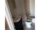 Bright bathroom featuring a white toilet, tub and sink with storage at 3439 Cox St, North Las Vegas, NV 89032
