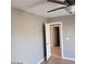 Bedroom with hardwood floors, neutral walls, white trim, and an open door at 3439 Cox St, North Las Vegas, NV 89032
